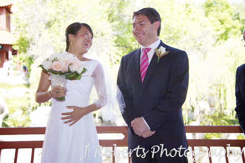 Bride and groom laughing during wedding ceremony - wedding photography sydney